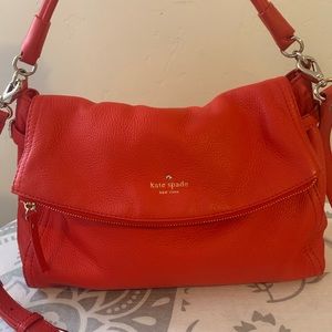 This Kate Spade is in perfect condition no flaws or damage is a vibrant orange